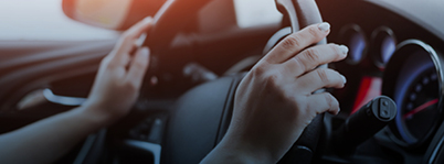 Hands on steering wheel of vehicle