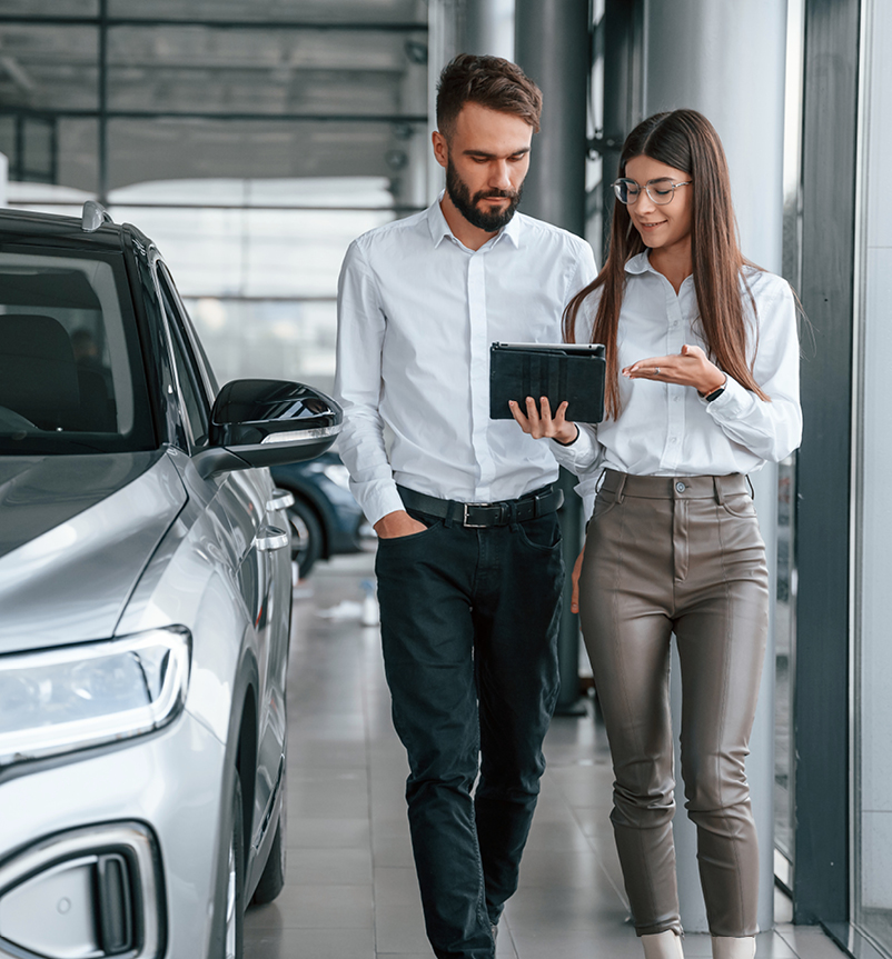 Man and women in car dealership